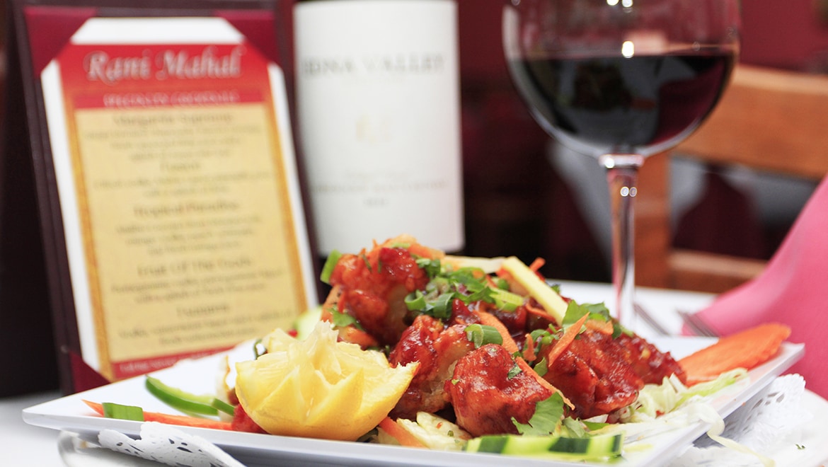 Chili chicken with a glass of red wine