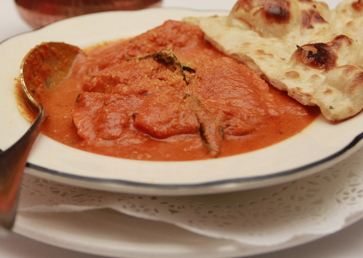 Curry with naan on the plate