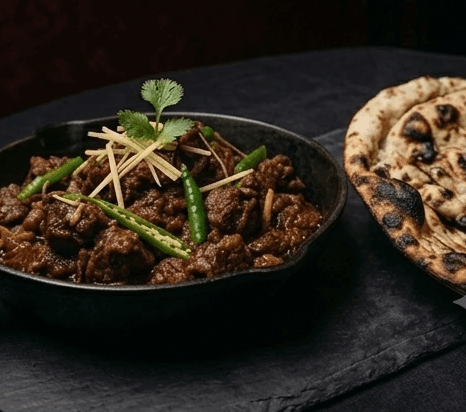 Concept: lamb kadai with naan, dark studio lighting